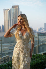 Female model wearing Yasmin Gold Wrap Dress - Cream / Gold- showcasing the latest ladies fashion with free delivery