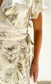 Female model wearing Yasmin Gold Wrap Dress - Cream / Gold- showcasing the latest ladies fashion with free delivery