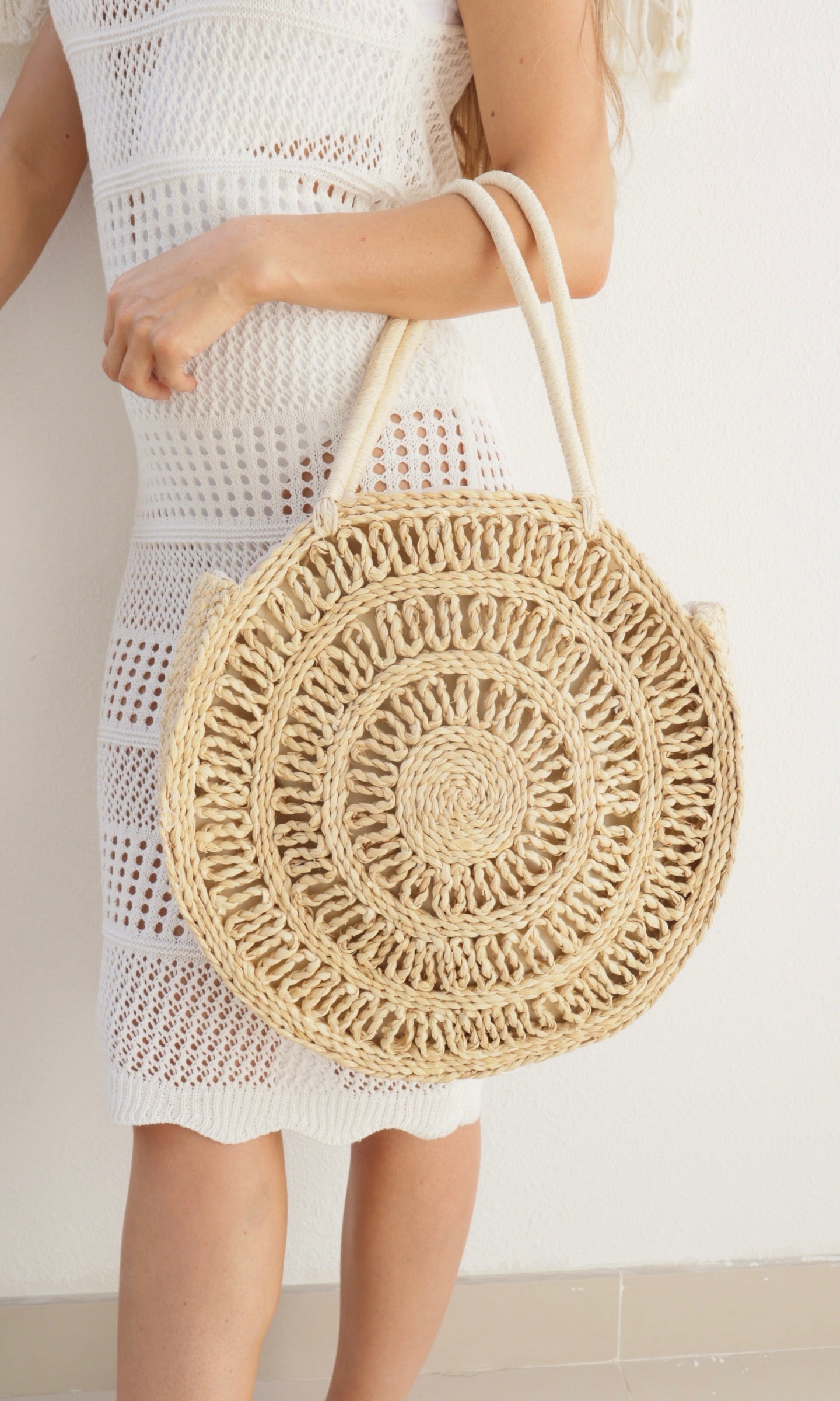 Female model wearing Rosie Circular Straw Bag - Natural- showcasing the latest ladies fashion with free delivery